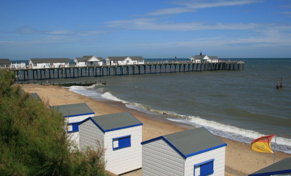 Southwold pier with the old style beach huts in the foreground